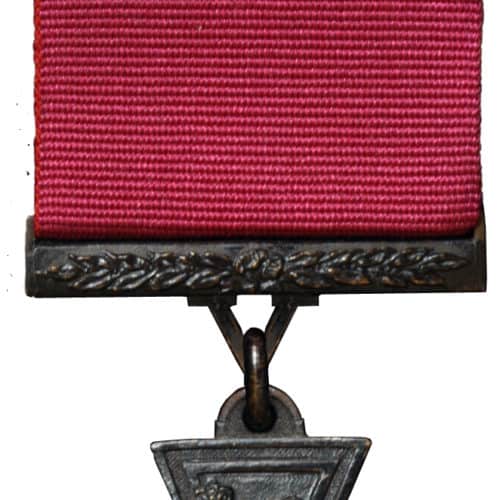 Victoria Cross (VC).  The premier award for gallantry, the VC may be awarded to all ranks of the services and civilians for gallantry in the presence of the enemy. It may be awarded posthumously.

Description: A cross patte in bronze. The obverse of the medal (shown here) bears a lion statant gardant on the royal crown, with the words 'FOR VALOUR' on a semi-circular scroll.  The reverse bears a circular panel inside which is engraved the date of the act for which the decoration was awarded. The reverse of the suspender is engraved with the rank, name and ship, regiment or squadron of the recipient.

Clasp.  A bronze bar ornamented with laurels may be issued to VC holders performing a further act of such bravery which would have merited award of the VC.

Ribbon.  Plain crimson.  Prior to 1918, a dark blue ribbon had been issued for the Royal Navy. When the ribbon alone is worn a replica of the cross in miniature is affixed to the centre of the ribbon.

History.  Instituted by Queen Victoria to cover all actions since the outbreak of the Crimean War in 1854, the Victoria Cross has been awarded 1356 times and 3 bars have been awarded.

The VC is made from the bronze of Russian guns captured at Sebastopol, though modern research suggests that Chinese guns may have been used at various times.